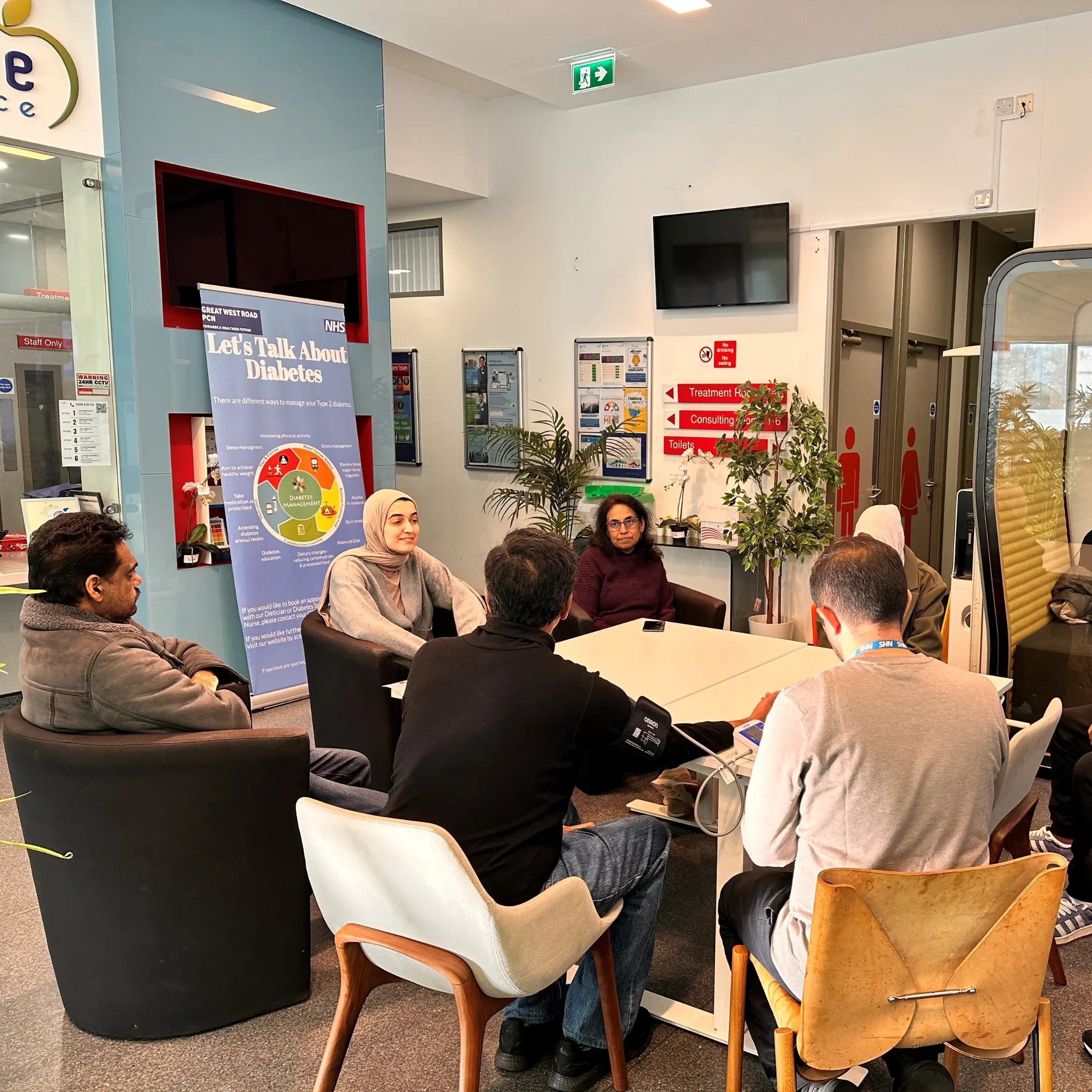 Group of staff and patients in a GP Practice - doing group patient consultations